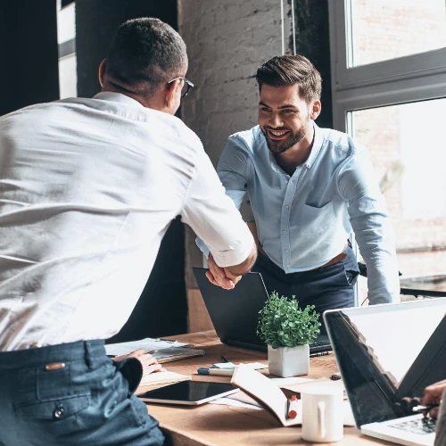 Two men in a meeting shaking hands