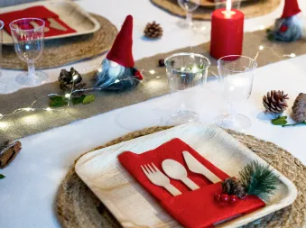Ett bord dekket til jul med engangsservise av tre