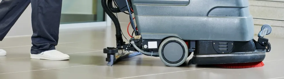 En person i sykepleieruniform som sitter ved ett skrive bord med diverse dokumenter og ett tastatur