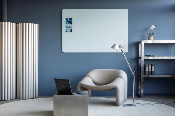 Ett rom med diverse møbler og en pastell blå glass tavle på veggen