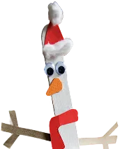 En ispinne som noen har pyntet til jul. Pinnenissen har på seg en rød lue.